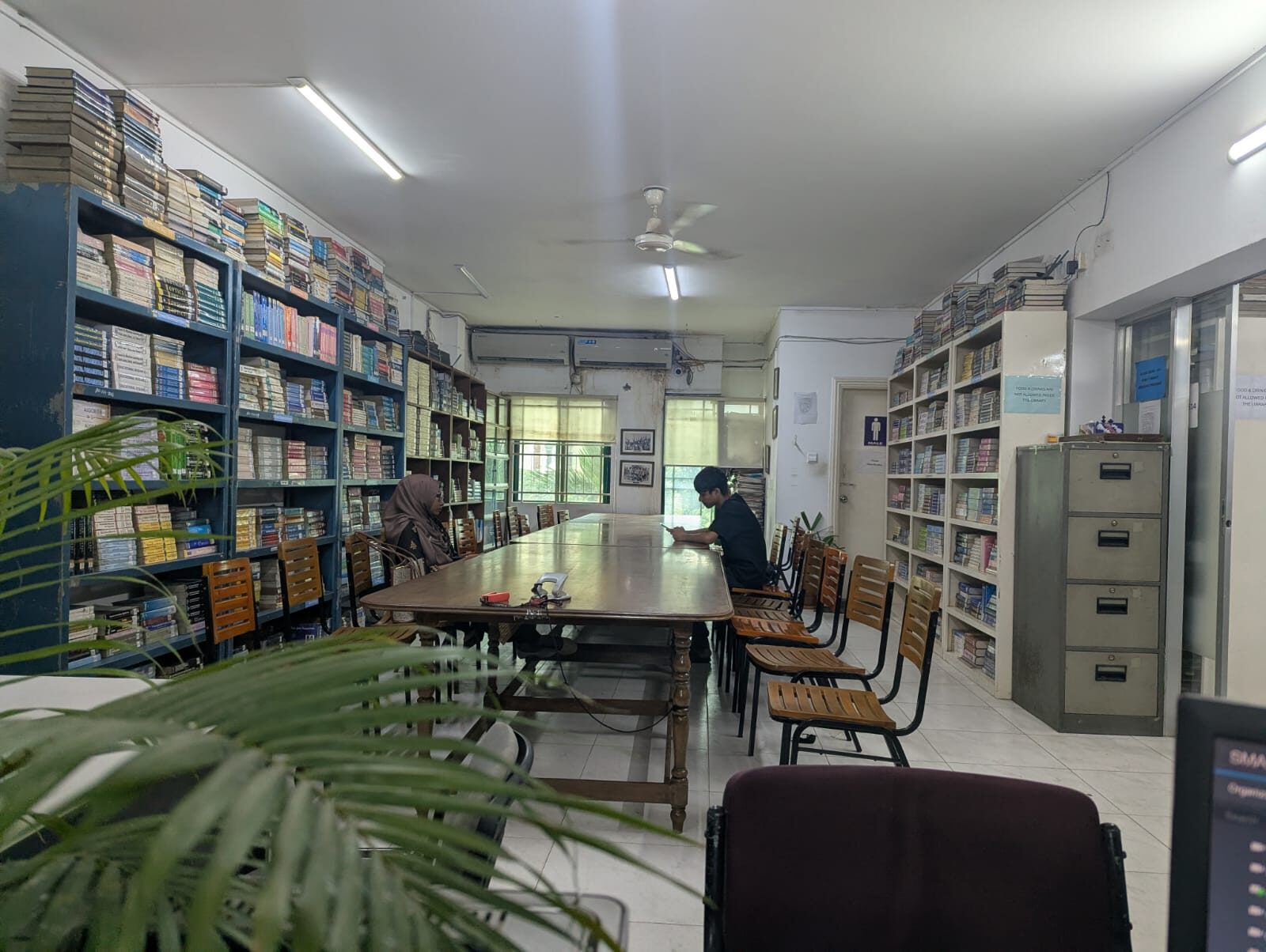 Students studying in the Presidency University Library reading room